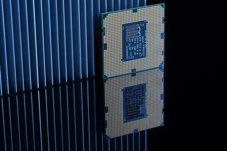 Close up of Computer Processor with Aluminum Heatsink on Black Reflective Background