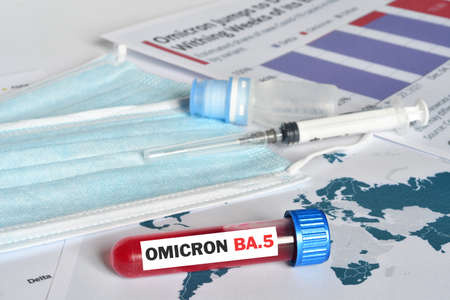 Blood tube for test detection of Virus Covid-19 Omicron BA.5 Variant on papers document with vaccine vial, syringe and surgical mask. Protection Concept against the New Variant from Virus SARS-CoV-2 "Omicron BA.5"の写真素材