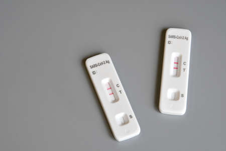 two SARS â€‘ CoV â€‘ 2 antigen test kit for self testing with positive results. One step...