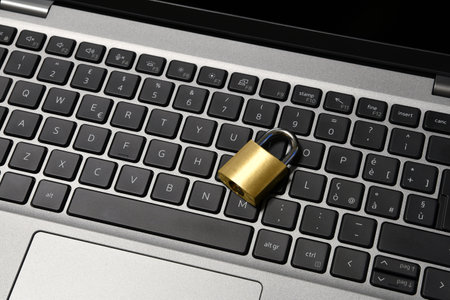 Computer security concept with a closed padlock on the keyboard