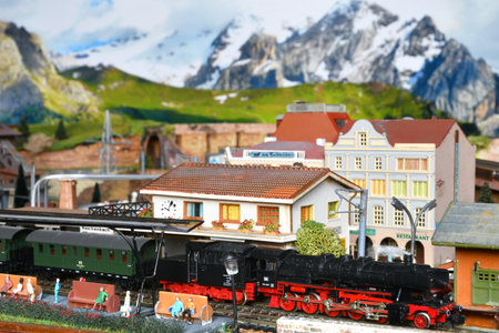 Miniature railway model with model steam locomotive train at train station on a mountains setting. Toy Trainの写真素材