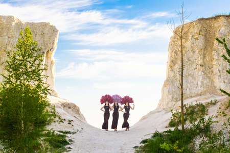 Three girls against blue sky in nature.の写真素材