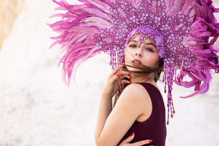 A beautiful young woman in Brazilian carnival costume and flowing hairの写真素材
