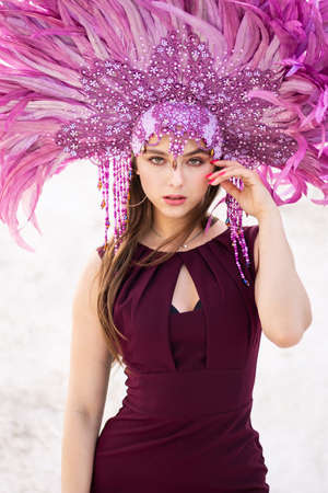 A girl with a large purple feather crown.の写真素材
