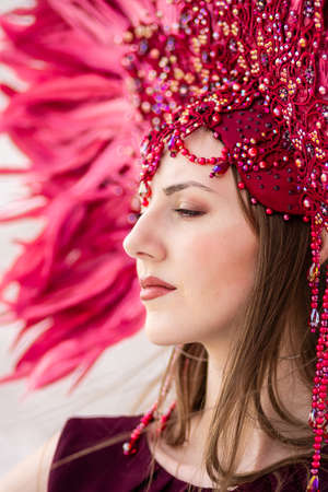 A beautiful thoughtful girl in carnival costume looks into the distanceの写真素材