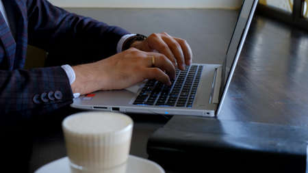 Typing on laptop keyboard in close-up. Hands typing on computer keys. programmer