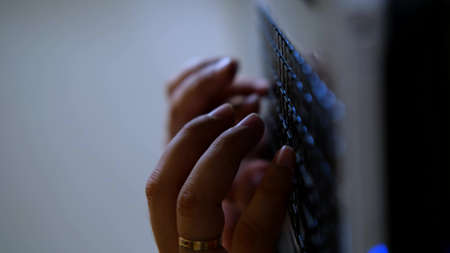 Typing on a laptop keyboard in close-up. Hands typing on computer keys. Hacker