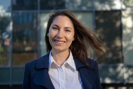 Attractive woman standing, smiling and looking at the camera