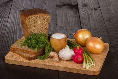 Bread with vegetables on black backgroundの写真素材