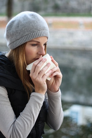 Woman blowing into tissueの写真素材