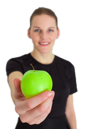 Woman Holding A Green Apple And Smilingの写真素材