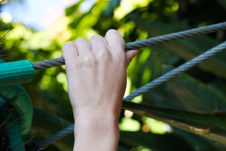 Hand holding onto a Wire rope in full strengthの写真素材