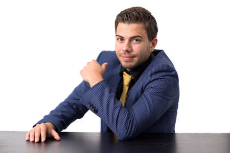 Businessman looking into camera while sitting on a cameraの写真素材