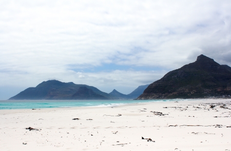 Beach of Kommetjie with an upcoming storm in the background and blue waterの写真素材