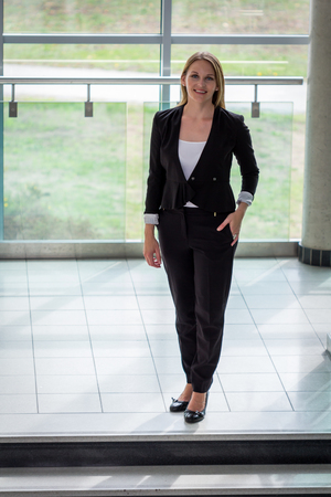 Businesswoman standing with a black jacket and black pantsの写真素材