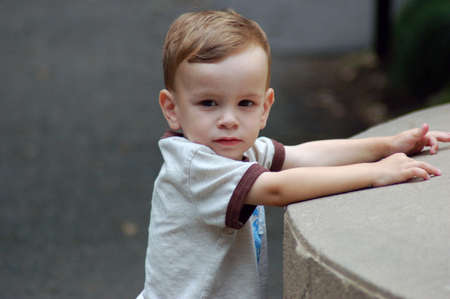 Little Boy Leaning on Wallの写真素材