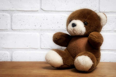 Brown teddy bear sitting on a tableの写真素材