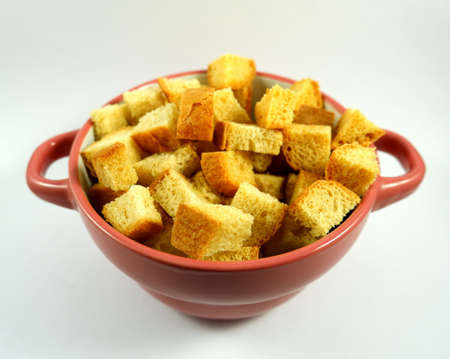 Bowl with small croutons on a white plate close upの写真素材