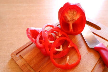 Bell pepper and kitchen knife on cutting board
