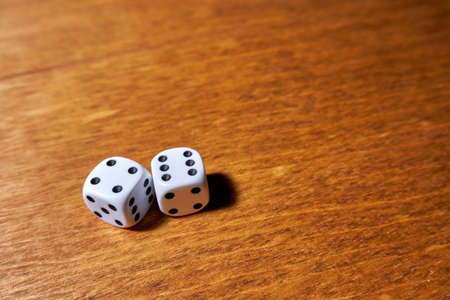 White dice on wooden surface