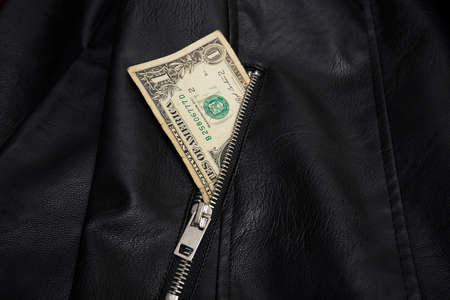 Dollar bill in leather jacket pocketの写真素材