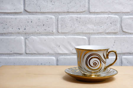 Beautiful cup and saucer on a wooden tableの写真素材