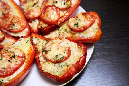 Stuffed red bell peppers on a plate close-upの写真素材