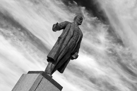 Ryazan, Russia - August 27, 2023: Monument to Vladimir Lenin against the sky. Dutch angle, black and...