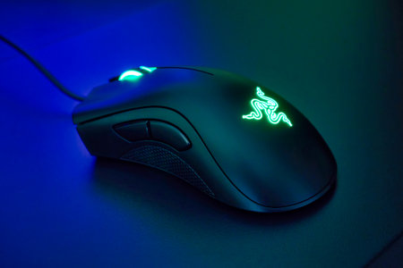 Ryazan, Russia - October 19, 2023: Razer Deathadder gaming mouse with glowing logo and scroll wheelのeditorial素材