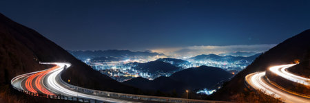 Night view of the road in the mountains with car light trailsの素材