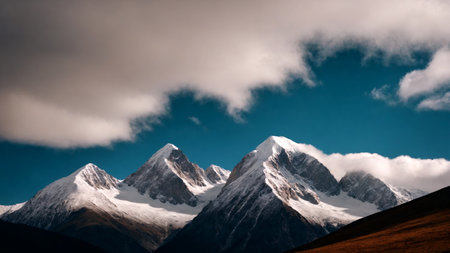 Mountain landscape with snow-capped peaks and cloudy skyの素材