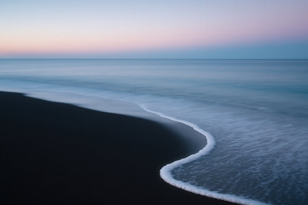 Beautiful seascape with black sand beach at sunsetの素材
