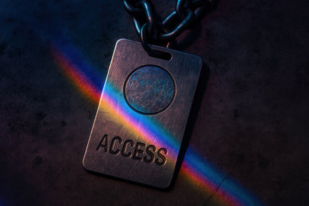 Metal Access Badge With Chain And Rainbow Light On Dark Surfaceの素材