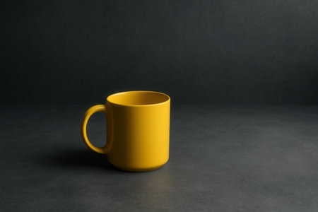 Yellow Ceramic Mug On Dark Minimalist Backgroundの素材