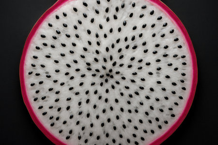Dragon Fruit Slice With Seeds On Black Backgroundの素材