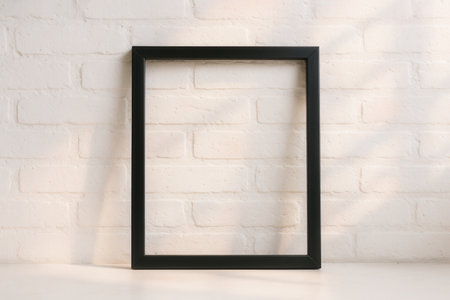 Minimalist Black Picture Frame On White Brick Wall With Empty Copy Space For Poster Or Artwork Mockupの素材