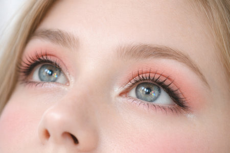 Close Up Of Blue Human Eyes With Pink Eyeshadow And Long Eyelashesの素材