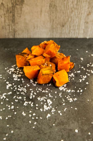 Roasted pumpkin on a black slate backgroundの写真素材