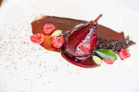poached pears delicious restaurant made on a chocolate smearの写真素材