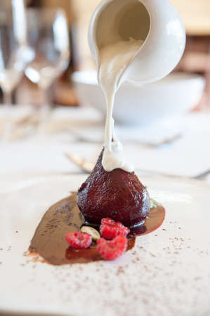 cream being poured onto a delicious poached pearの写真素材