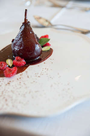 poached pears delicious restaurant made on a chocolate smearの写真素材