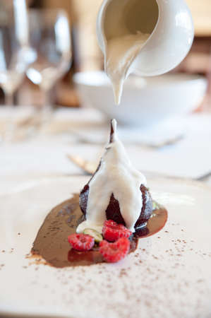 cream being poured onto a delicious poached pearの写真素材