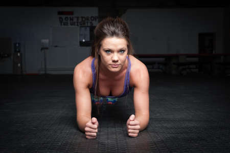 woman doing plank exercise inside a gymの写真素材