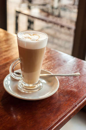 cafe latte in a glass in natural window lightの写真素材