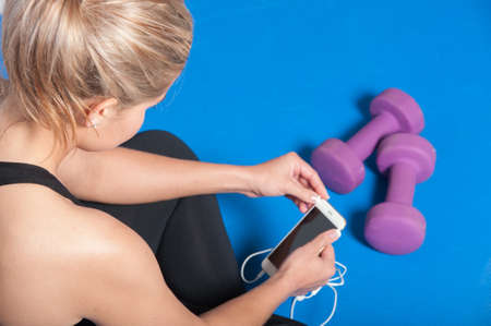 Female fitness model resting after an intense workout