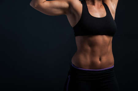 Image of fitness woman in sports clothing Young female model with muscular body