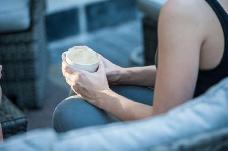 close up image of a girl holding an empty coffee cupの写真素材
