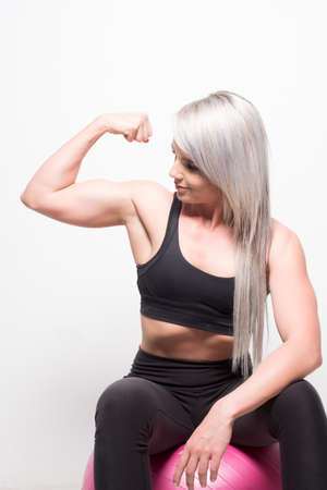 solated studio image of an athletic blond female with attitudeの写真素材