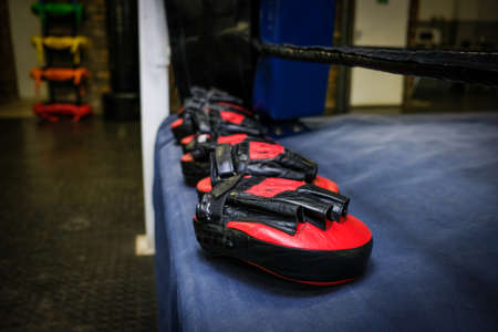 boxing sparring training pads laid on the edge of a boxing ringの写真素材