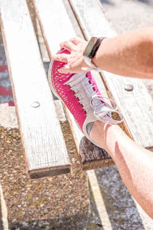vibrant image of a feamale doing a hamstring stretch outdoors